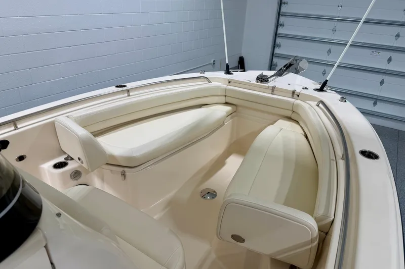 Slide: The Image of 2023 Grady-White Fisherman 257 boat interior with cushioned seating in a garage. - 22