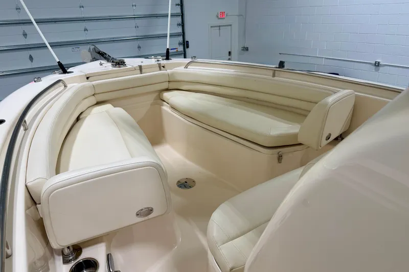 Slide: The Image of 2023 Grady-White Fisherman 257 boat interior with cream seating in a garage setting. - 23