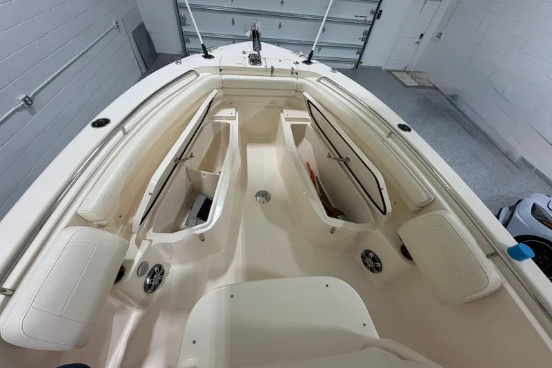 Slide: The Image of 2023 Grady-White Fisherman 257 boat interior with storage compartments in a garage setting. - 24