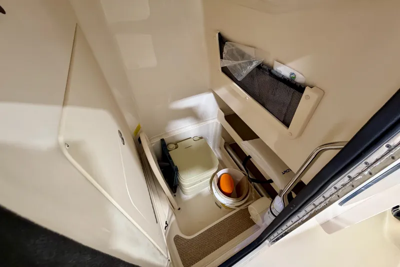 Slide: The Image of 2023 Grady-White Fisherman 257 boat interior storage compartment with equipment and supplies. - 26
