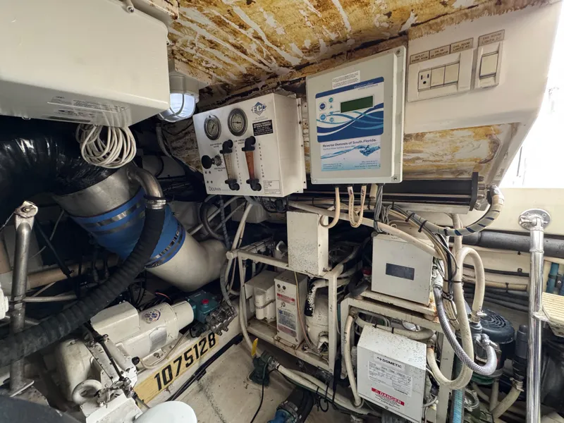 Slide: The Image of Engine room of 1999 Cabo 45 Express boat with control panels and machinery. - 47