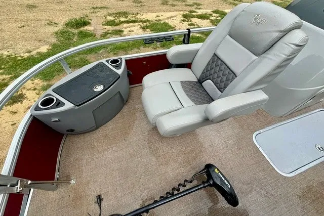 Slide: The Image of 2023 Ranger 223F boat interior with plush captain's chair and control panel. - 14