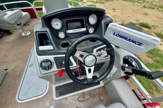 Slide: The Image of 2023 Ranger 223F boat dashboard with steering wheel and Lowrance navigation system. - 10
