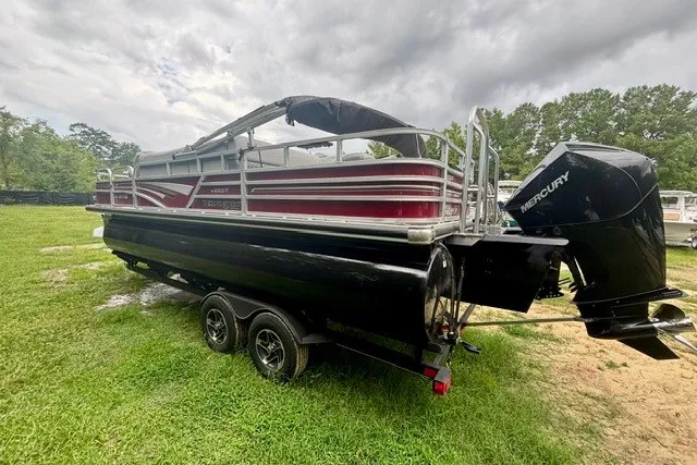Slide: The Image of 2023 Ranger 223F pontoon boat with Mercury engine on grassy area under cloudy sky. - 3