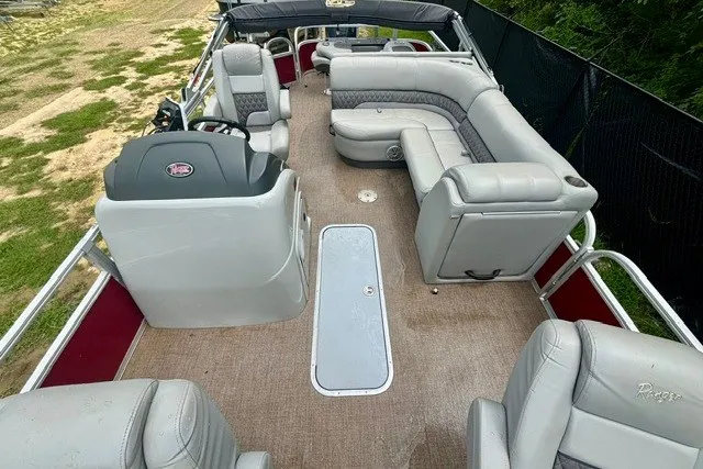 Slide: The Image of 2023 Ranger 223F pontoon boat interior with plush seating and steering console. - 13