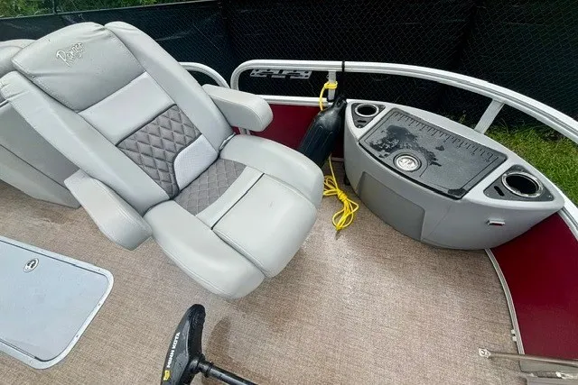 Slide: The Image of 2023 Ranger 223F boat interior with gray seating and control panel. - 15