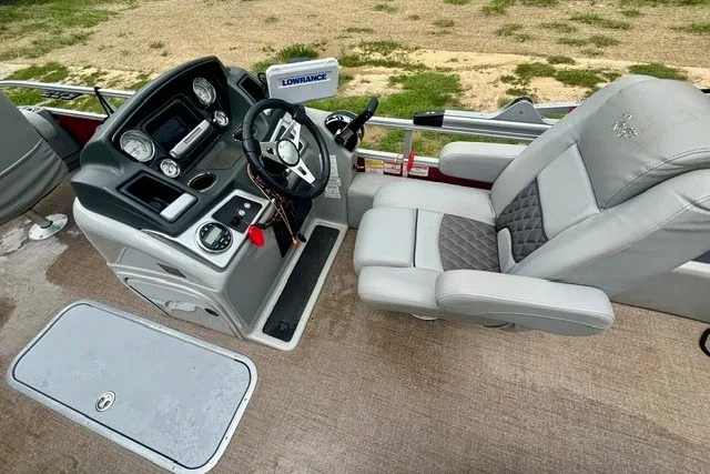 Slide: The Image of 2023 Ranger 223F boat interior with steering console and comfortable seating. - 11