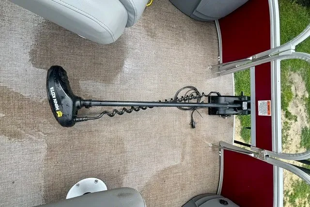 Slide: The Image of Trolling motor on 2023 Ranger 223F boat deck with red interior accents. - 18