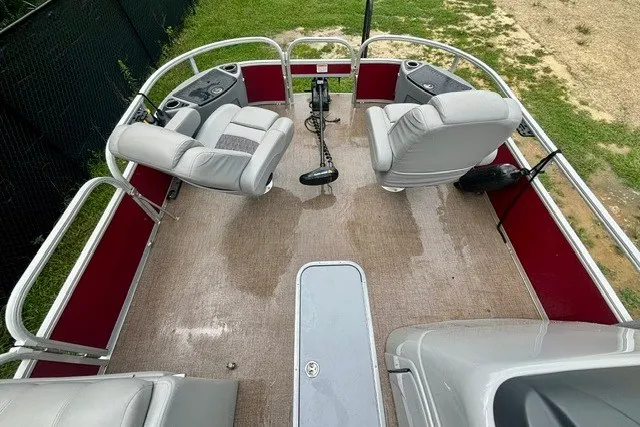 Slide: The Image of 2023 Ranger 223F boat interior with seating and steering, featuring red and gray accents. - 16