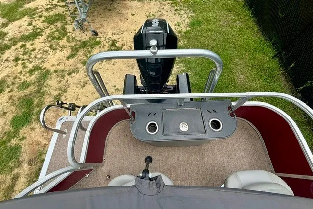 Slide: The Image of 2023 Ranger 223F boat deck with motor, cup holders, and seating, viewed from above. - 7