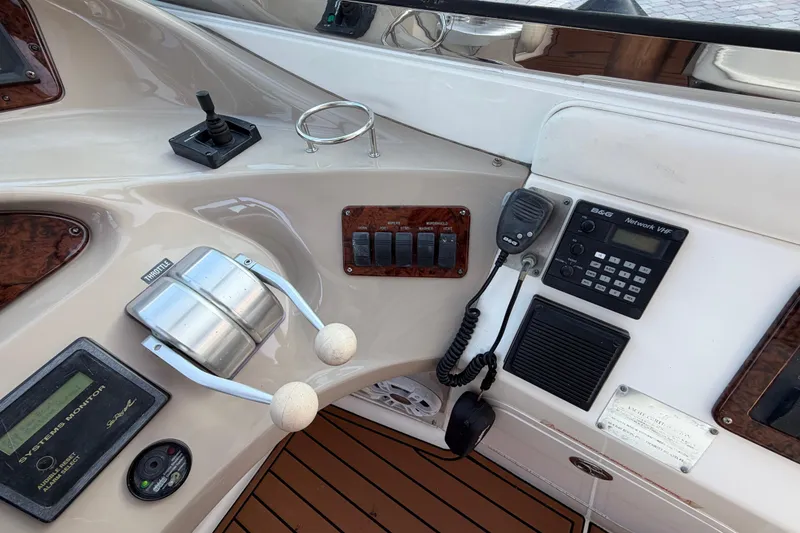Slide: The Image of Control panel of a 2001 Sea Ray Sundancer 510 yacht with throttle and VHF radio. - 17