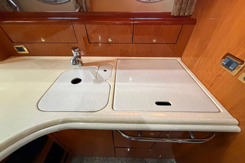 Slide: The Image of Luxurious kitchen area in a 2001 Sea Ray Sundancer 510 yacht, featuring sleek countertops. - 25