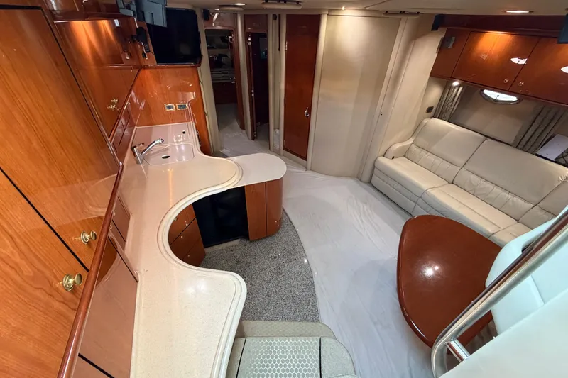 Slide: The Image of Luxurious interior of 2001 Sea Ray Sundancer 510 yacht with elegant wood finishes and plush seating. - 20