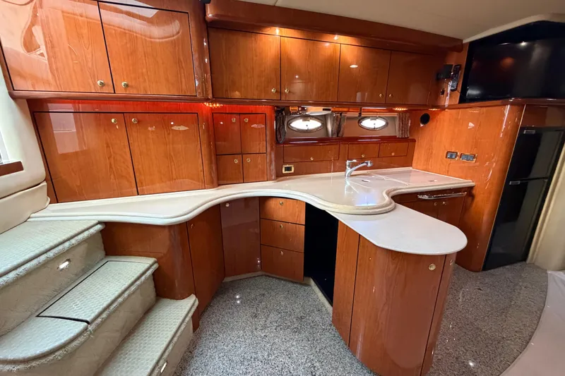 Slide: The Image of Luxurious 2001 Sea Ray Sundancer 510 yacht interior with elegant wood cabinetry and modern kitchen amenities. - 22