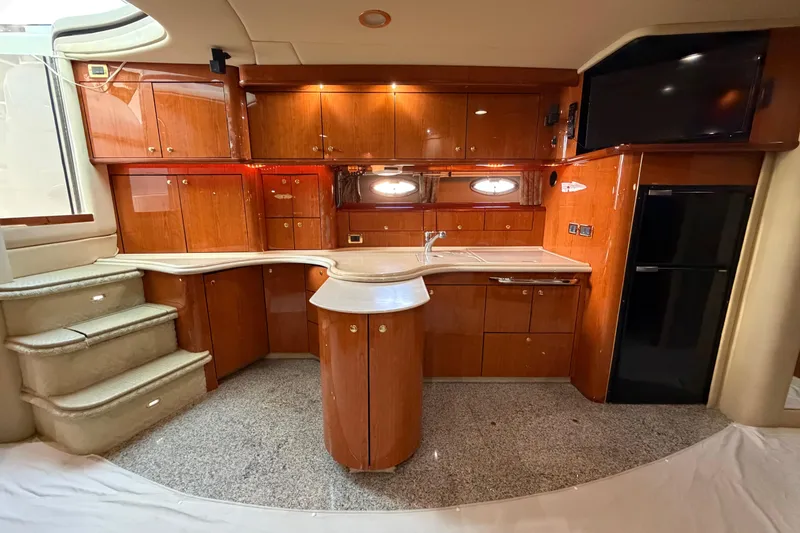 Slide: The Image of Luxurious 2001 Sea Ray Sundancer 510 yacht interior with elegant wood cabinetry and modern amenities. - 23