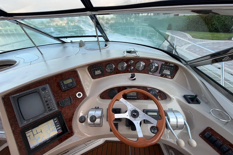Slide: The Image of Cockpit of 2001 Sea Ray Sundancer 510 yacht with navigation instruments and wooden steering wheel. - 15