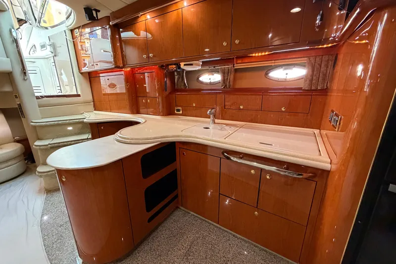 Slide: The Image of Luxurious 2001 Sea Ray Sundancer 510 yacht interior with elegant wood cabinetry and modern amenities. - 24