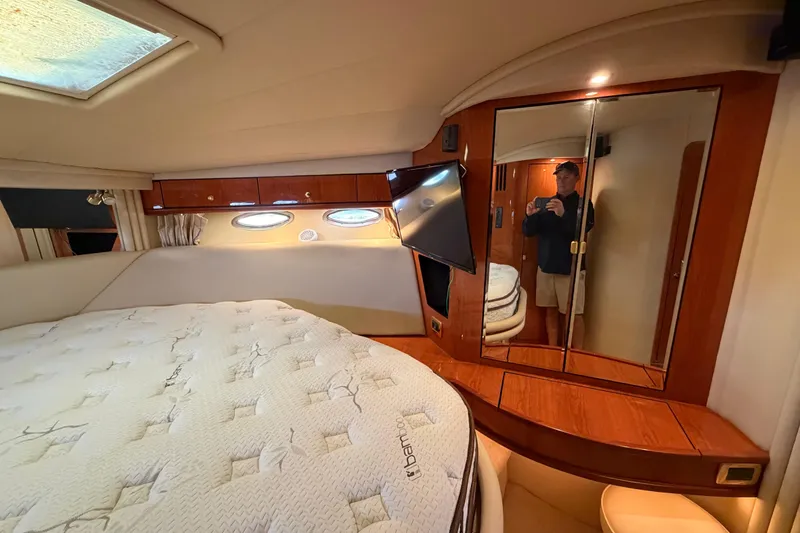 Slide: The Image of Luxurious 2001 Sea Ray Sundancer 510 cabin with cozy bed, mirrored closet, and porthole windows. - 30