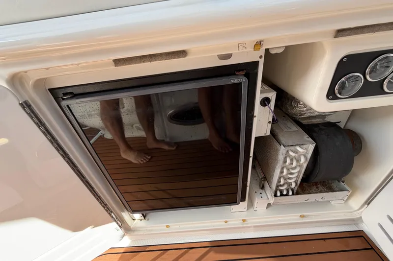 Slide: The Image of 2001 Sea Ray Sundancer 510 boat interior with Norcold refrigerator and control panel. - 19