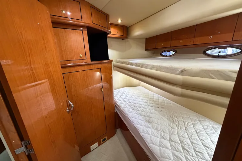 Slide: The Image of 2001 Sea Ray Sundancer 510 cabin with wooden cabinetry and twin bunk beds. - 35