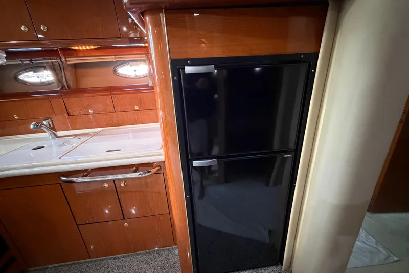 Slide: The Image of Luxurious 2001 Sea Ray Sundancer 510 yacht kitchen with sleek cabinetry and modern appliances. - 27
