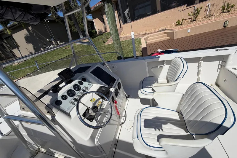 Slide: The Image of 1995 Pro-Line 21 Sport boat interior with steering console and cushioned seats. - 12