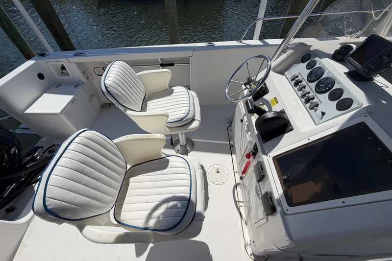 Slide: The Image of 1995 Pro-Line 21 Sport boat cockpit with steering wheel, gauges, and cushioned seats. - 13