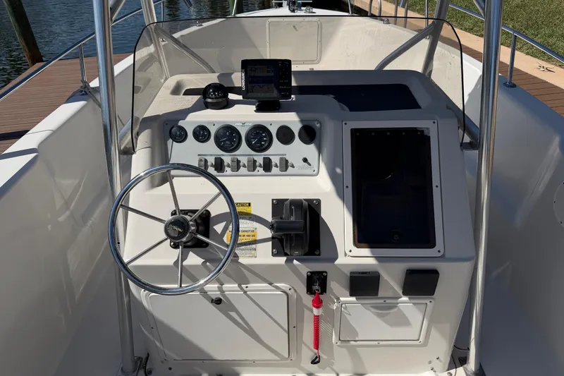 Slide: The Image of 1995 Pro-Line 21 Sport boat dashboard with steering wheel and instrument panel. - 9