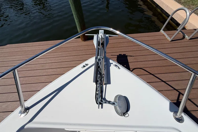 Slide: The Image of Bow view of a 1995 Pro-Line 21 Sport boat docked by wooden pier. - 19