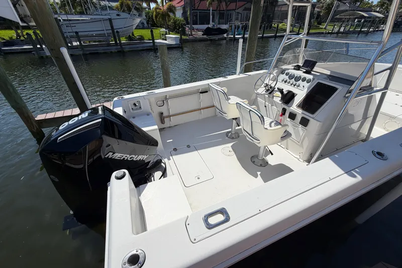 Slide: The Image of 1995 Pro-Line 21 Sport boat with Mercury engine, docked in a marina. - 15