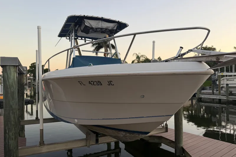 Slide: The Image of 1995 Pro-Line 21 Sport boat docked at marina during sunset. - 20
