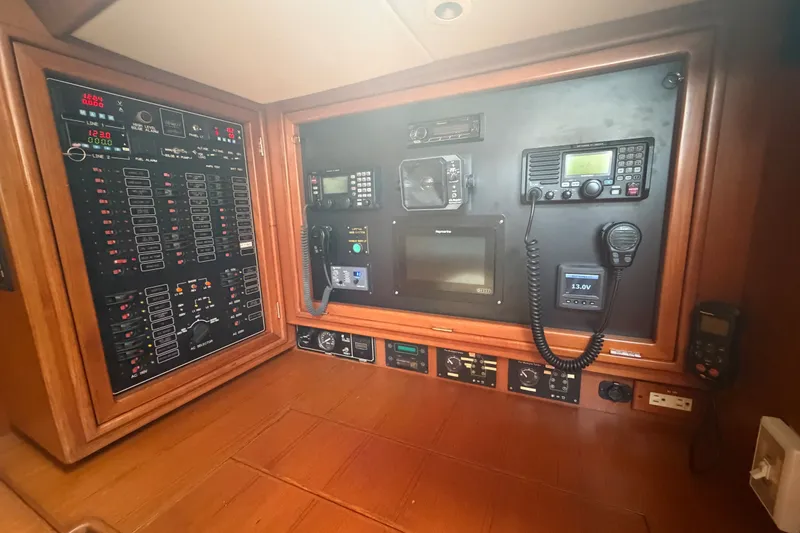 Slide: The Image of Navigation and control panel of a 2009 Hylas 54 yacht, featuring advanced electronics. - 12