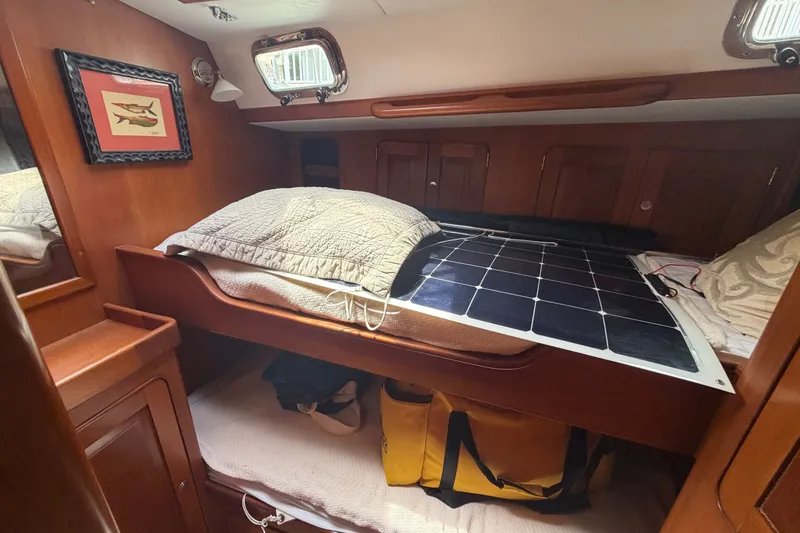 Slide: The Image of Cozy cabin interior of 2009 Hylas 54 yacht with solar panel on bed. - 16