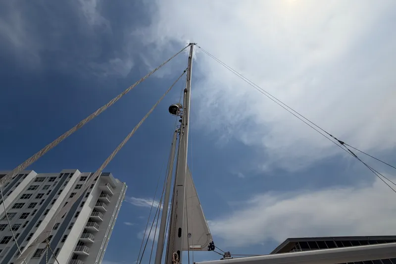Slide: The Image of Sailboat mast of 2009 Hylas 54 against a cloudy sky, with buildings in the background. - 40