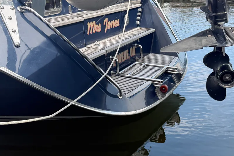 Slide: The Image of Stern view of 2009 Hylas 54 yacht "Mrs. Jones" docked on calm water. - 42