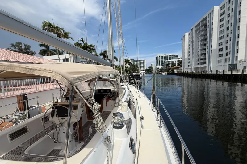 Slide: The Image of Sailing yacht Hylas 54 (2009) docked by waterfront buildings and palm trees. - 31