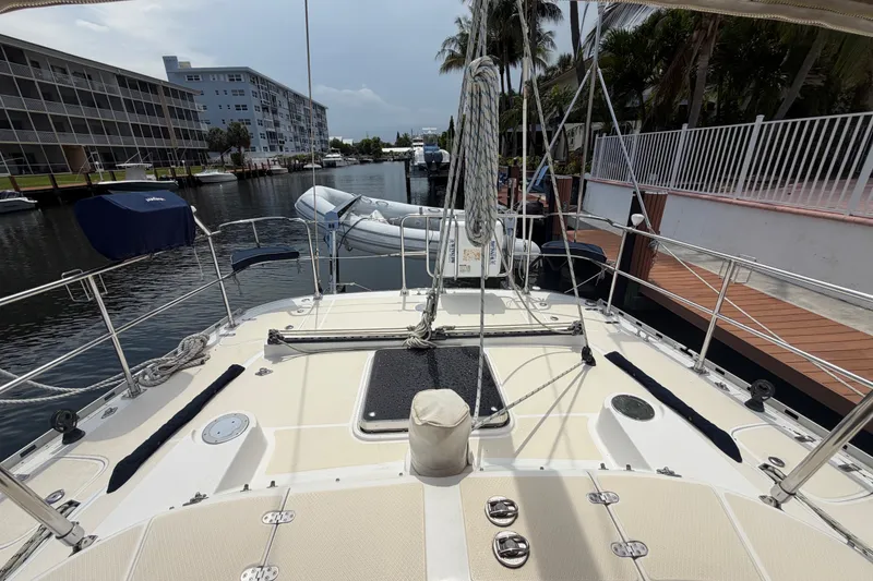 Slide: The Image of 2009 Hylas 54 yacht deck view, docked near waterfront buildings and palm trees. - 29
