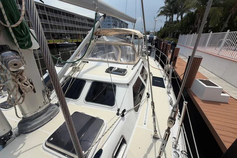 Slide: The Image of 2009 Hylas 54 sailboat docked, showcasing deck and rigging details. - 37