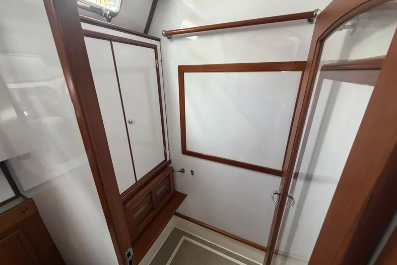 Slide: The Image of Interior of 2009 Hylas 54 yacht featuring wooden cabinetry and glass door. - 23