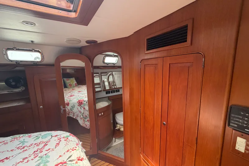Slide: The Image of Interior of 2009 Hylas 54 yacht with wood paneling and floral bedding. - 21
