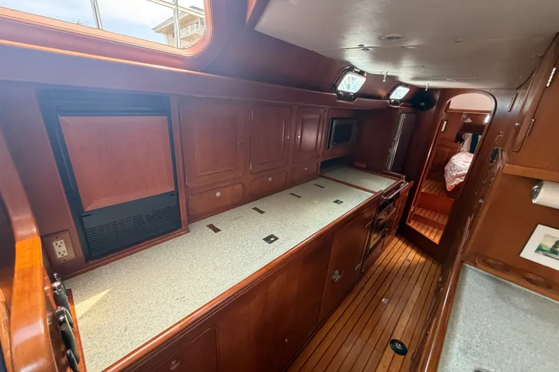 Slide: The Image of Luxurious interior of a 2009 Hylas 54 yacht featuring wooden cabinetry and modern amenities. - 18