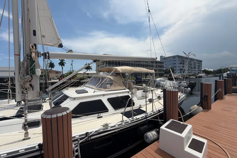 Slide: The Image of Sailboat docked at marina, Hylas 54 model, 2009, with clear skies and waterfront buildings. - 39