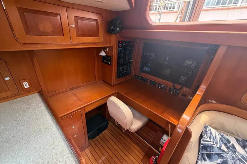 Slide: The Image of Luxurious 2009 Hylas 54 yacht interior with wooden cabinetry and navigation station. - 10