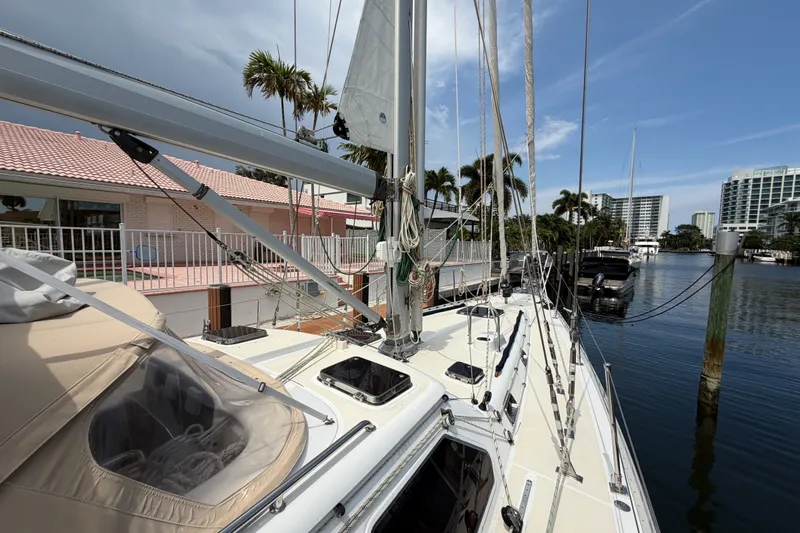 Slide: The Image of Sailing yacht Hylas 54 (2009) docked by waterfront homes and palm trees. - 32