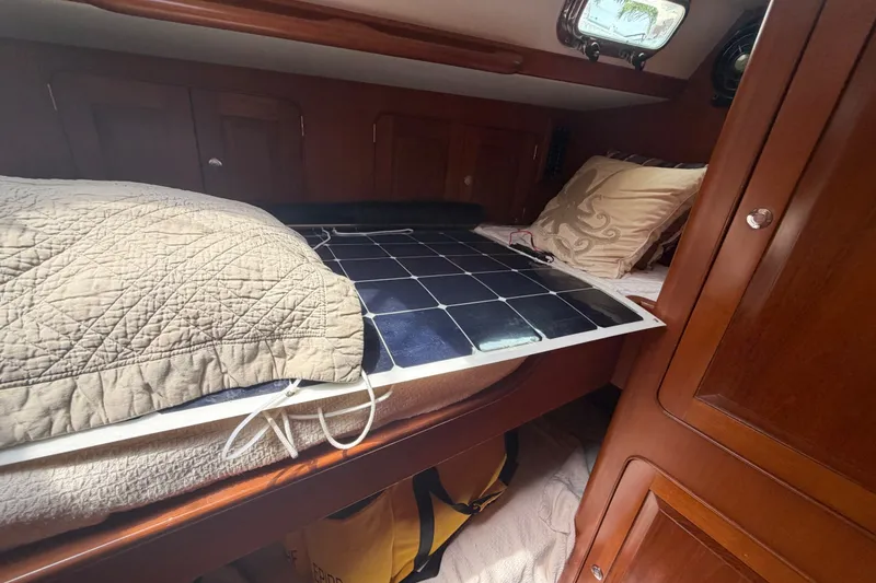 Slide: The Image of Cozy cabin interior of 2009 Hylas 54 yacht with solar panel on bed. - 17