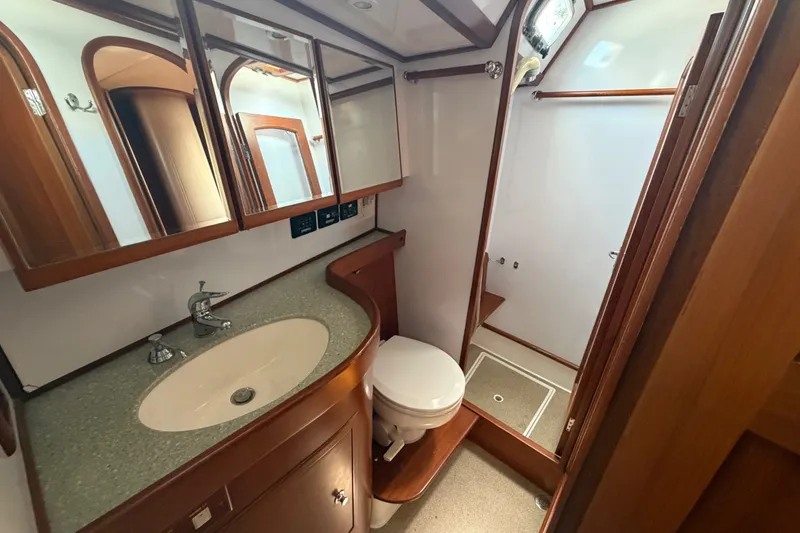 Slide: The Image of Luxurious 2009 Hylas 54 yacht bathroom with wooden cabinetry and modern fixtures. - 15