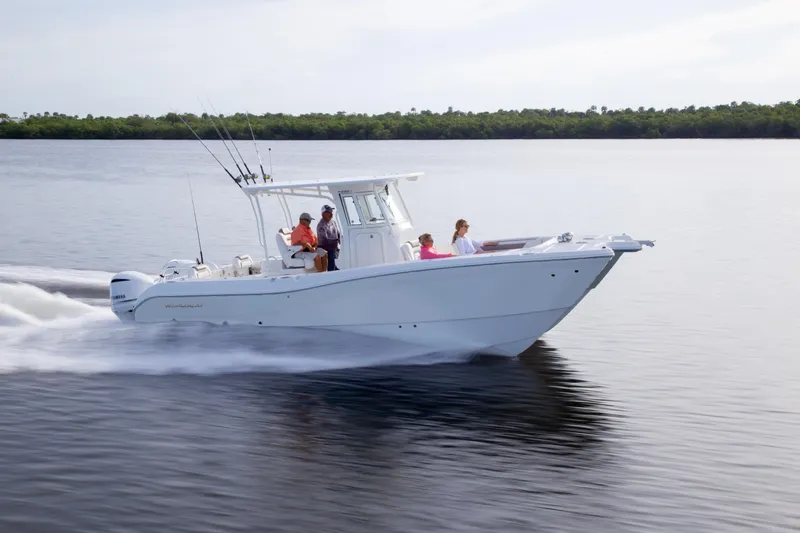 Slide: The Image of 2026 World Cat 295CC boat cruising on calm water with passengers onboard. - 9