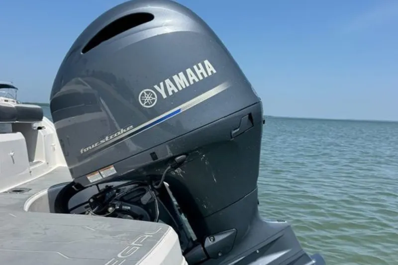 Slide: The Image of 2020 Regal 21 OBX boat with Yamaha outboard motor on a calm sea. - 9