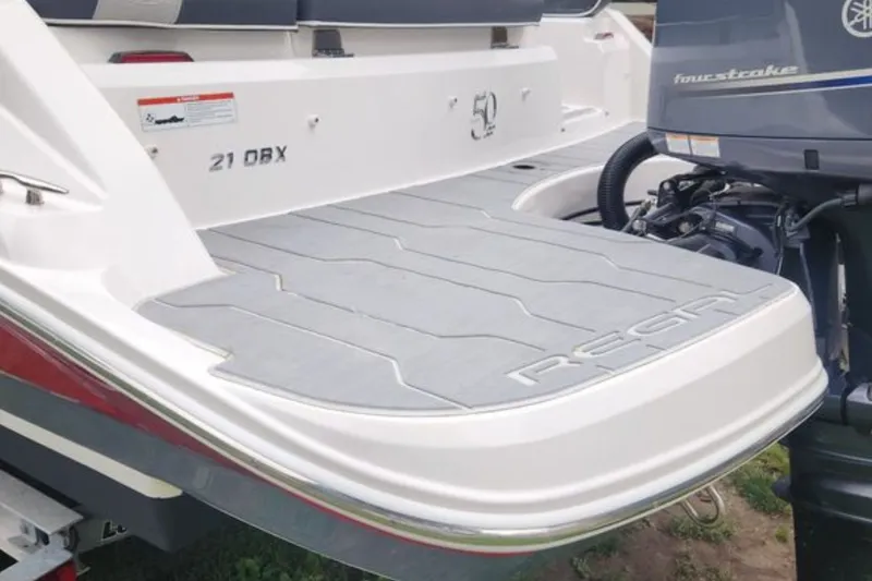 Slide: The Image of 2020 Regal 21 OBX boat with Yamaha outboard motor, featuring a sleek swim platform. - 8