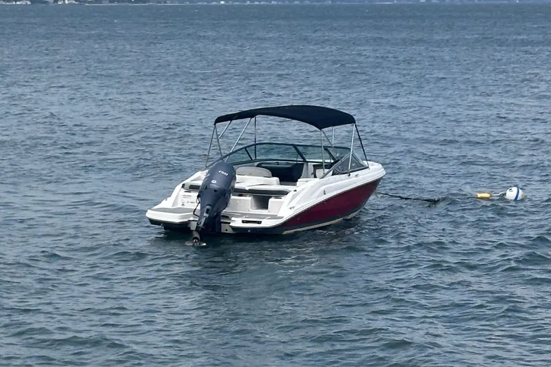 Slide: The Image of 2020 Regal 21 OBX boat with outboard motor on calm water. - 3